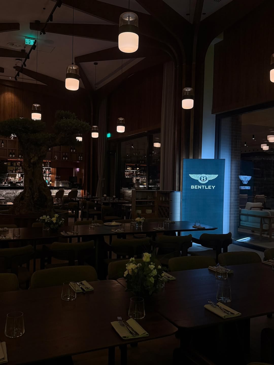 Bentley branded display inside the Issa Resort restaurant at night